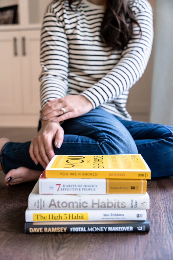 Creative business owner showcases business books during brand photoshoot