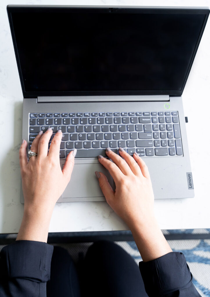 Stock image of woman's hands on laptop